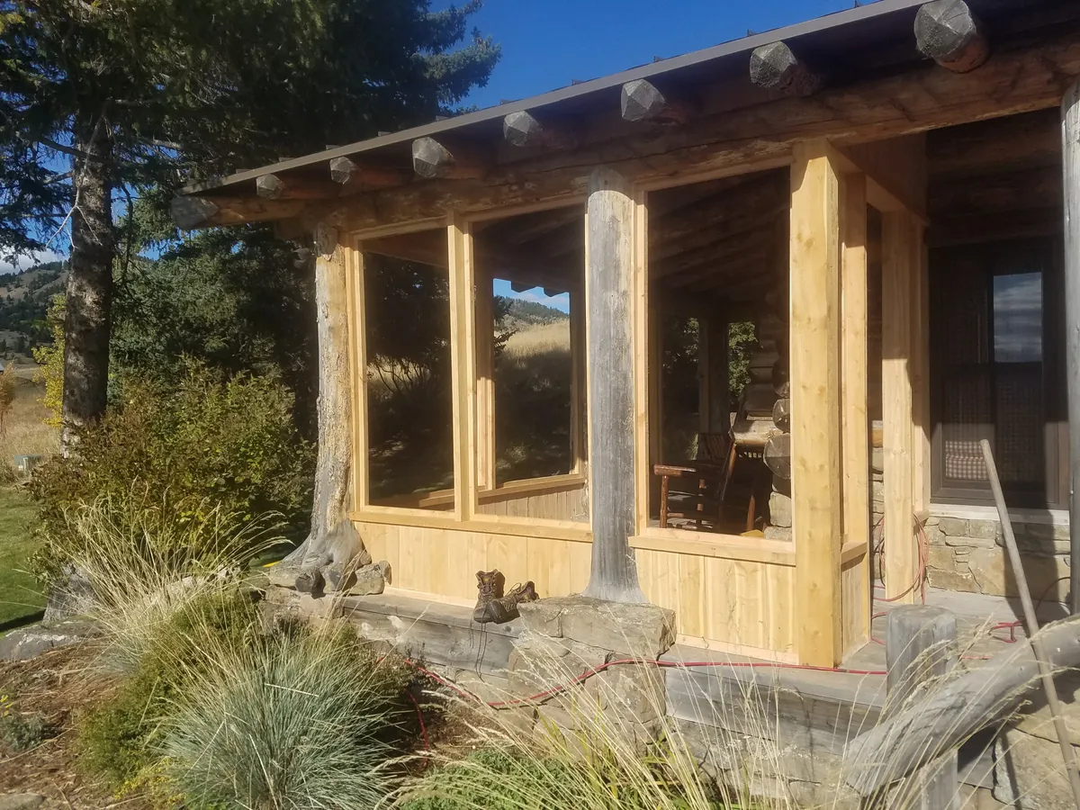 Cedar deck board installation over joist framing on green-sided home