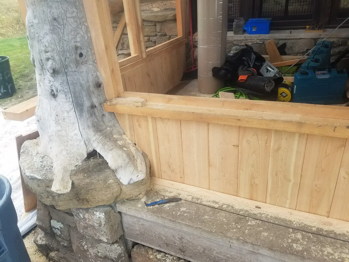 Cedar deck under timber frame pergola with open rafter roof in Bozeman MT