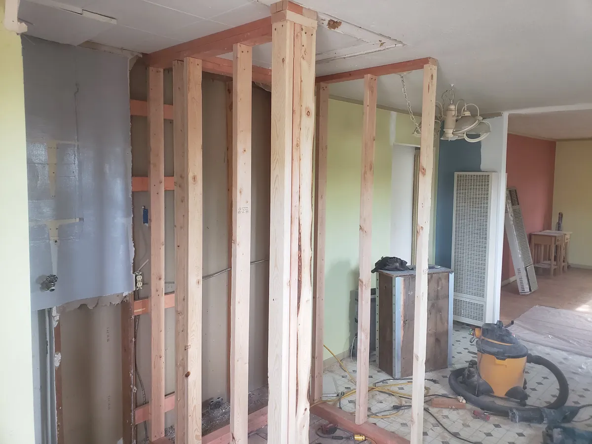Kitchen remodel with fresh white walls and refinished hardwood floors