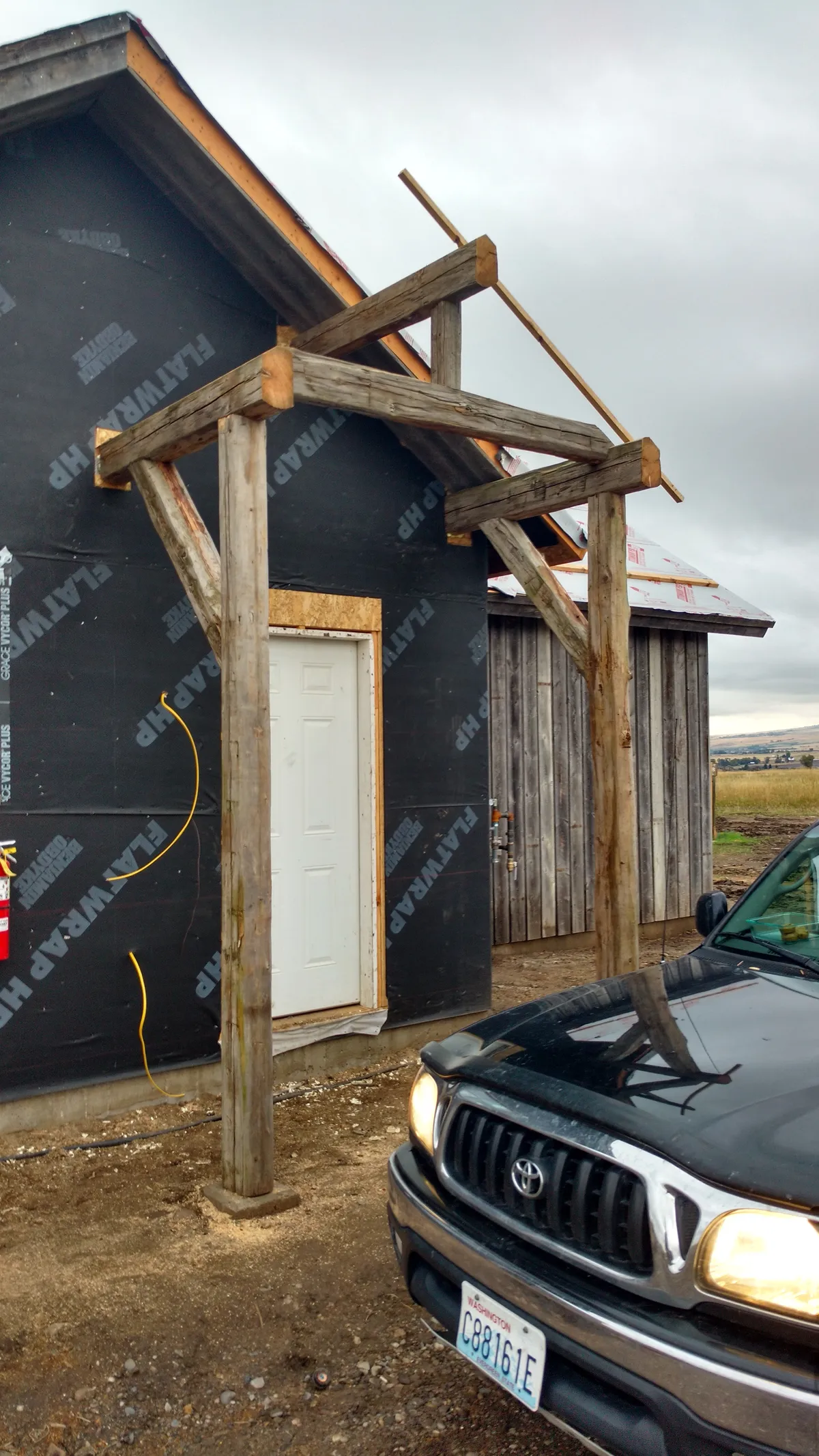 Completed covered porch exterior with finished trim and roofing