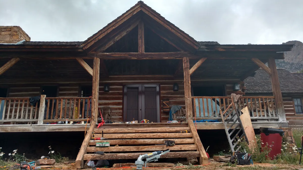 Covered porch with decorative bracket and corbel details at beam connections