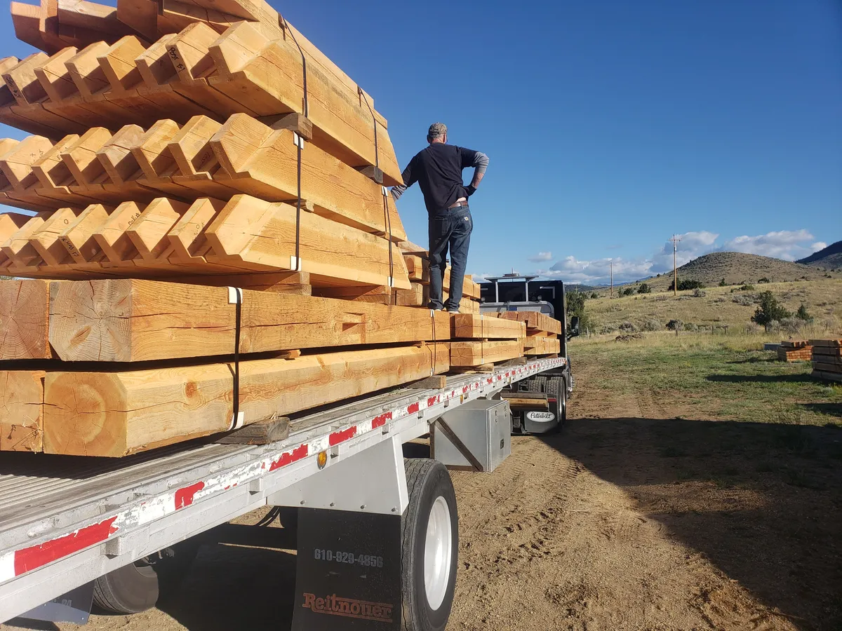 Completed timber frame cabin structure with roof and walls framed